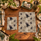 Raven Tapestry printable papers in two sizes displayed on a wooden crafting table.