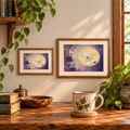 Moonlit Flight crane and golden moon artwork displayed in two landscape wooden frames.